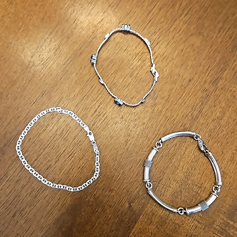 Three silver-toned bracelets - at least one is sterling silver - Picture 1 of 5